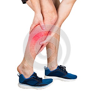 Athlete feeling calf pain from exercise isolated over white background. Sportsman suffering muscle cramp