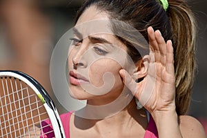 Athlete Female Tennis Player Listening With Tennis Racket