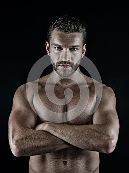 Athlete with folded hands on muscular bare torso, chest, belly