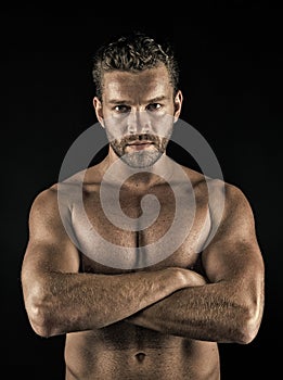 Athlete with folded hands on muscular bare torso, chest, belly