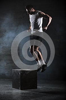 Athlete gave exercise. Jumping on the box. Phase