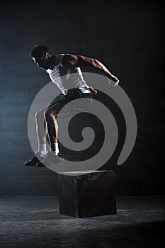 Athlete gave exercise. Jumping on the box. Phase