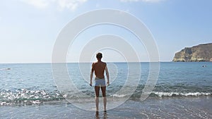 Athlete getting tempered standing in water and doing strange physical exercises