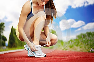 Athlete girl trying shoes