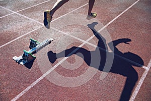 Athlete in Gold Shoes Sprinting Across Starting Line