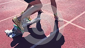 Athlete in Gold Shoes Sprinting Across Starting Line