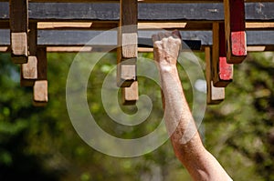 athlete hand at a hanging obstacle at an obstacle course race, OCR photo