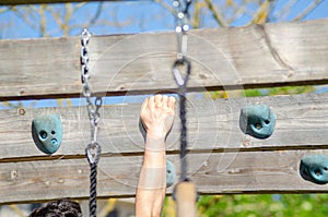 athlete hand at a hanging obstacle at an obstacle course race, OCR photo