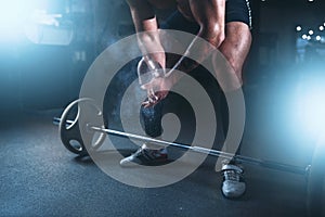 Athlete hands in powder and talc, barbell exercise