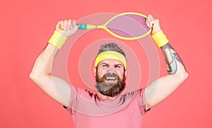 Athlete hipster hold tennis racket in hand red background. Tennis player vintage fashion. Tennis sport and entertainment