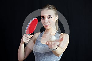 Beautiful girl with a tennis racket and a ball.