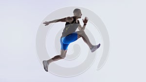 Athlete jumping forward in extended mid-stride.