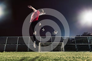 Athlete kicking soccer ball towards goal