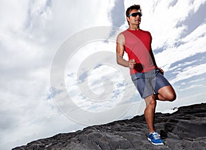 Athlete male person, running and outdoor for fitness, health and wellness in activewear and sunglasses. Man, jog and