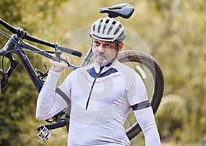 Athlete, man and carrying mountain bike outdoor for cardio exercise, sports race and training in nature. Mature cyclist