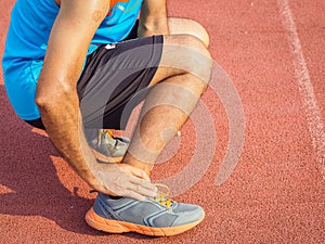 Athlete man has ankle injury, sprained leg during running training. healthcare and sport concept.