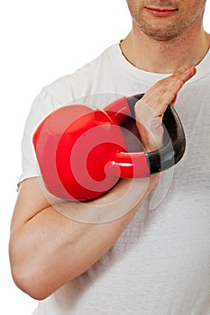 Athlete man holding the red kettlebell