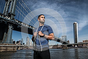 Athlete man with jump rope ready for outdoors workout in New York City