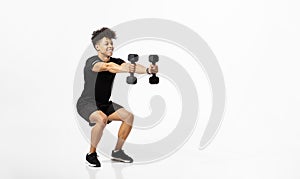 athlete man performing squats holding dumbbells weights on white background