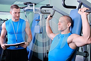 Athlete man with personal fitness trainer