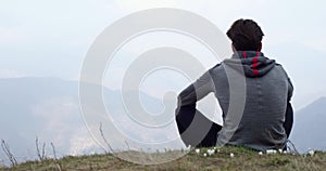 Athlete man runner resting sitted.Real people adult trail running sport training in autumn or winter in wild mountain