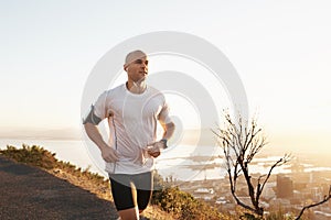 Athlete, man and running in road with music for sport, exercise and fitness for competition or marathon in nature