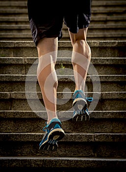 Athlete man with strong leg muscles training and running urban city staircase in sport fitness and healthy lifestyle concept