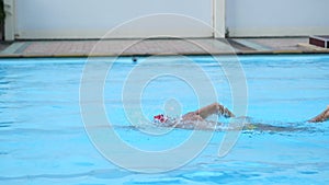 Athlete man swimming breaststroke in the swimming pool.