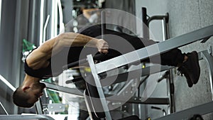 Athlete man training force push up and pull up exercise on bars in gym