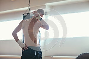 Athlete man wiping the sweat after hard workout