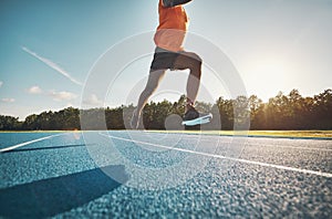 Athlete in mid air while sprinting down a running track