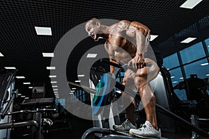 Athlete muscular bodybuilder in the gym training back