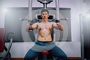 Athlete muscular bodybuilder training on simulator in the gym, strong male.Close Up Men in Gym Exercise Concepts for Body Health.