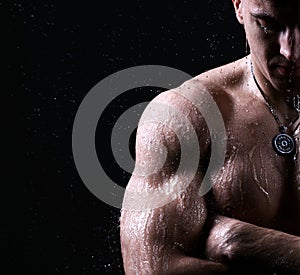 athlete muscular brutal bodybuilder strong male naked torso posing under water drops shower