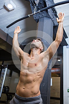 athlete with naked torso working in gym