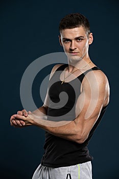 An athlete outside the bodybuilding waters shows off his muscles by flexing his arm muscles.