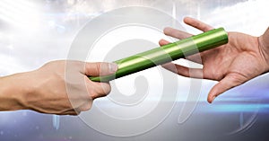 Athlete passing baton against digitally generated background