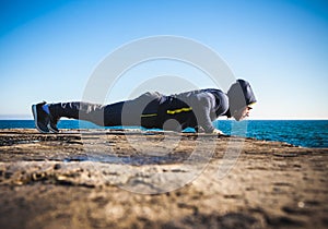 Athlete performing exercises on beach