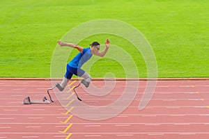 Athlete with prosthetics sprints instantly from start, displaying exceptional speed on stadium track photo