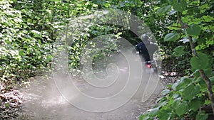 Athlete in protective gear on a motorcycle Enduro starts, dust and dirt fly from under the wheels