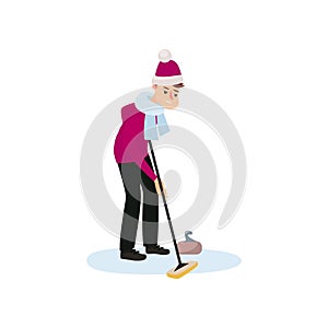 An athlete in a red hat and scarf on the ice is rubbing the floor with a brush, thus pushing a stone.