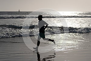 athlete run fast to win in the ocean. morning workout activity. healthy man running on beach.