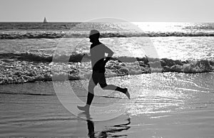 athlete run fast to win in the ocean. morning workout activity. healthy man running on beach.
