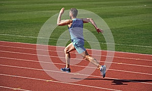 athlete runner do aerobic or anaerobic load. man start running on stadium. fitness gym outdoor. muscular athletic runner