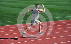 athlete runner do aerobic or anaerobic load. man start running on stadium. fitness gym outdoor. muscular athletic runner