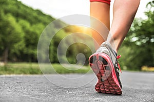 Athlete runner feet running on road