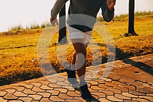 Athlete runner feet running on road, Jogging concept at outdoors. Man running for exercise..Athlete runner feet running on road,