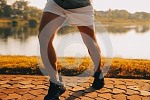 Athlete runner feet running on road, Jogging concept at outdoors. Man running for exercise..Athlete runner feet running on road,