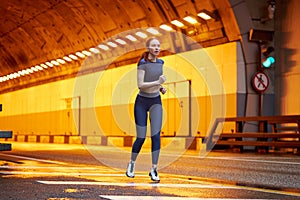 Athlete runner running on road. redhead fit woman jog workout wellness concept.