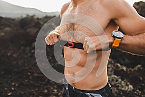 Athlete runner wearing chest heart rate monitor